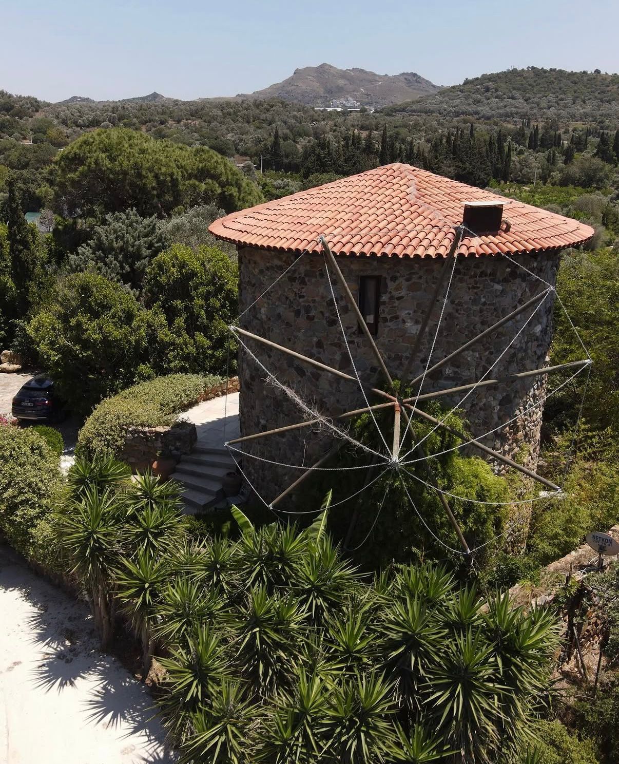 Restored stone windmill with Bodrum hills