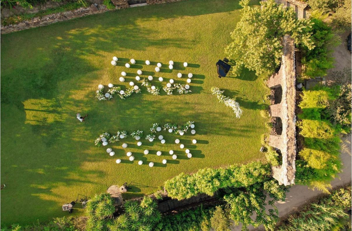 Aerial view of wedding ceremony setup on the lawn