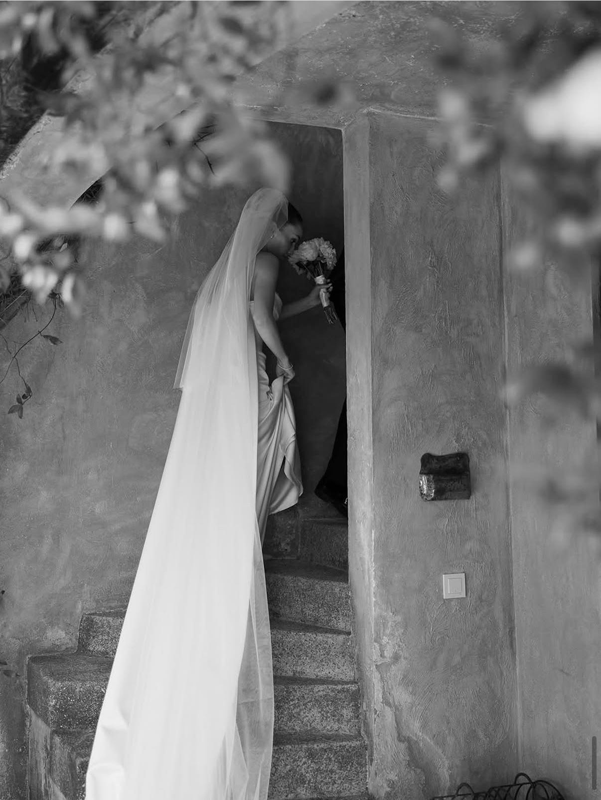 Bride ascending the stone stairway — black and white
