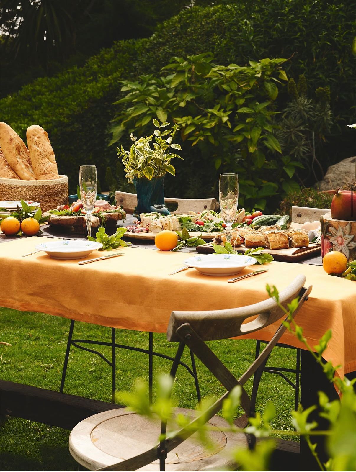 Sun-drenched garden lunch with bread and citrus
