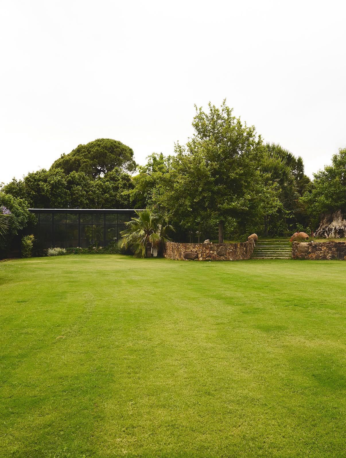 Sweeping lawn with the glass pavilion beyond