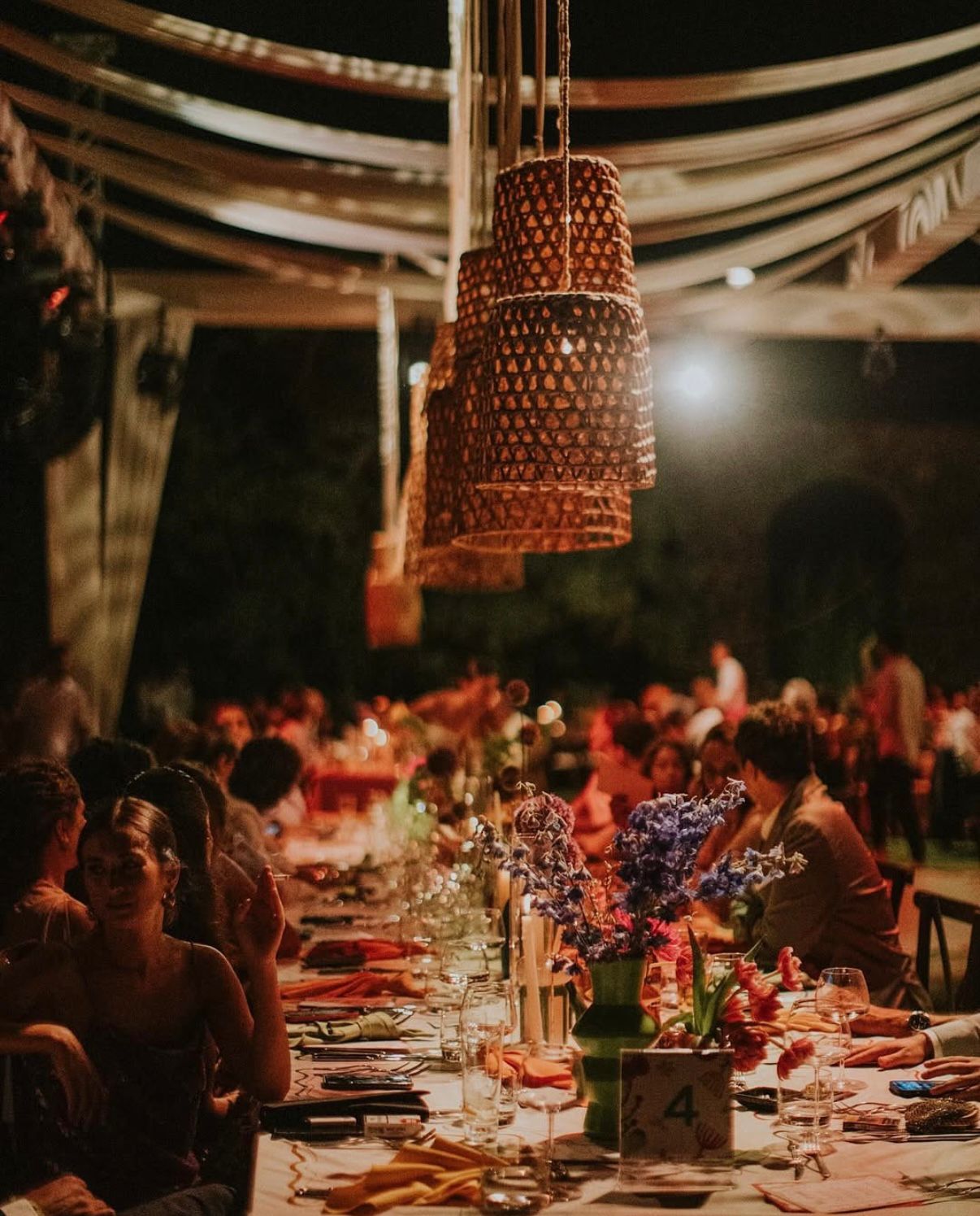 Wedding reception under woven lanterns at night